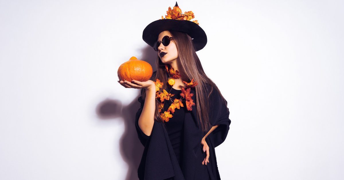 a young beautiful gothic girl in the shape of a witch in hallowe